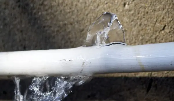 A frozen pipe that split and is spraying water in a Kannapolis, NC home